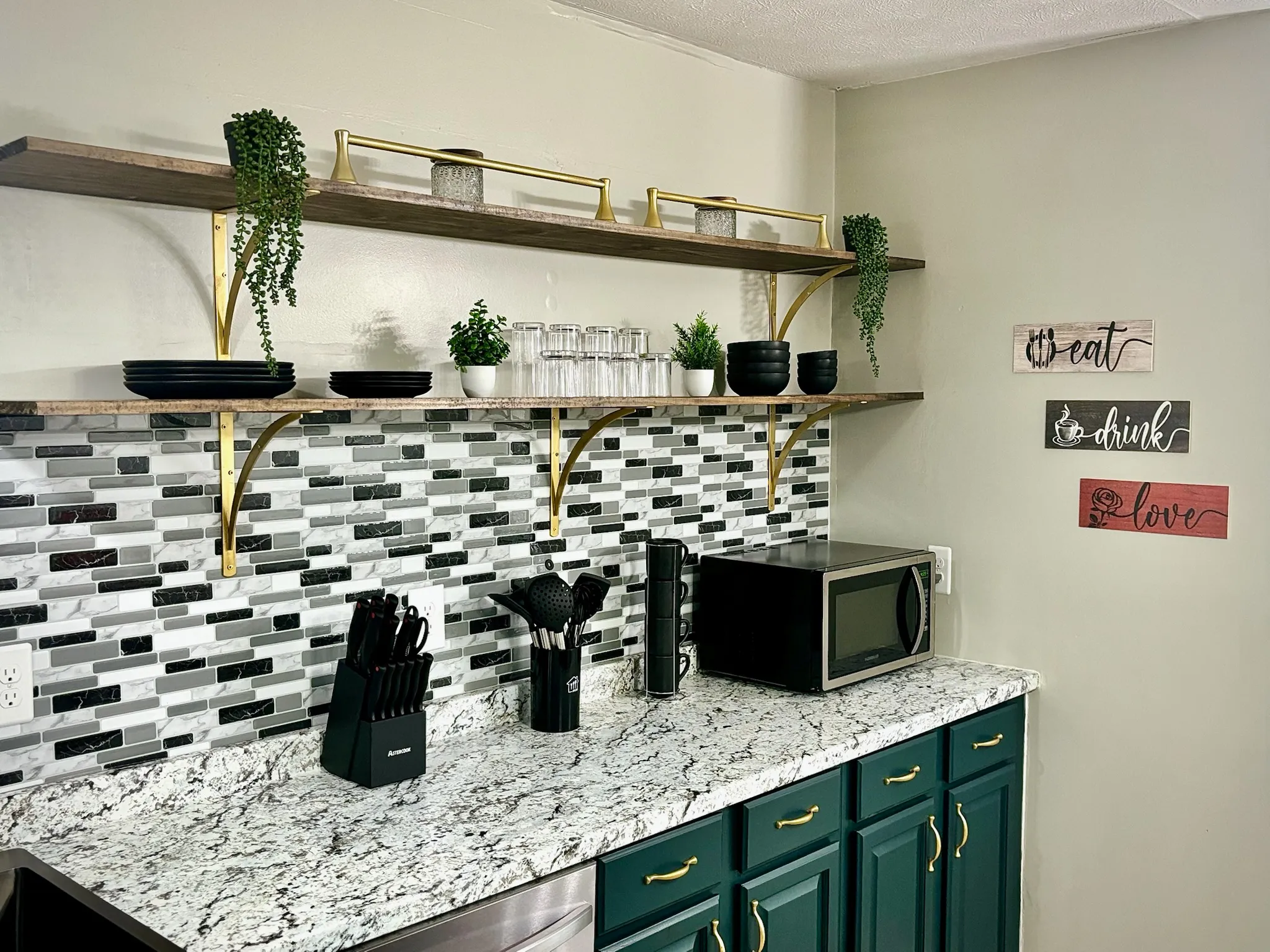 Kitchen countertop with glasses, plates, utensils etc..